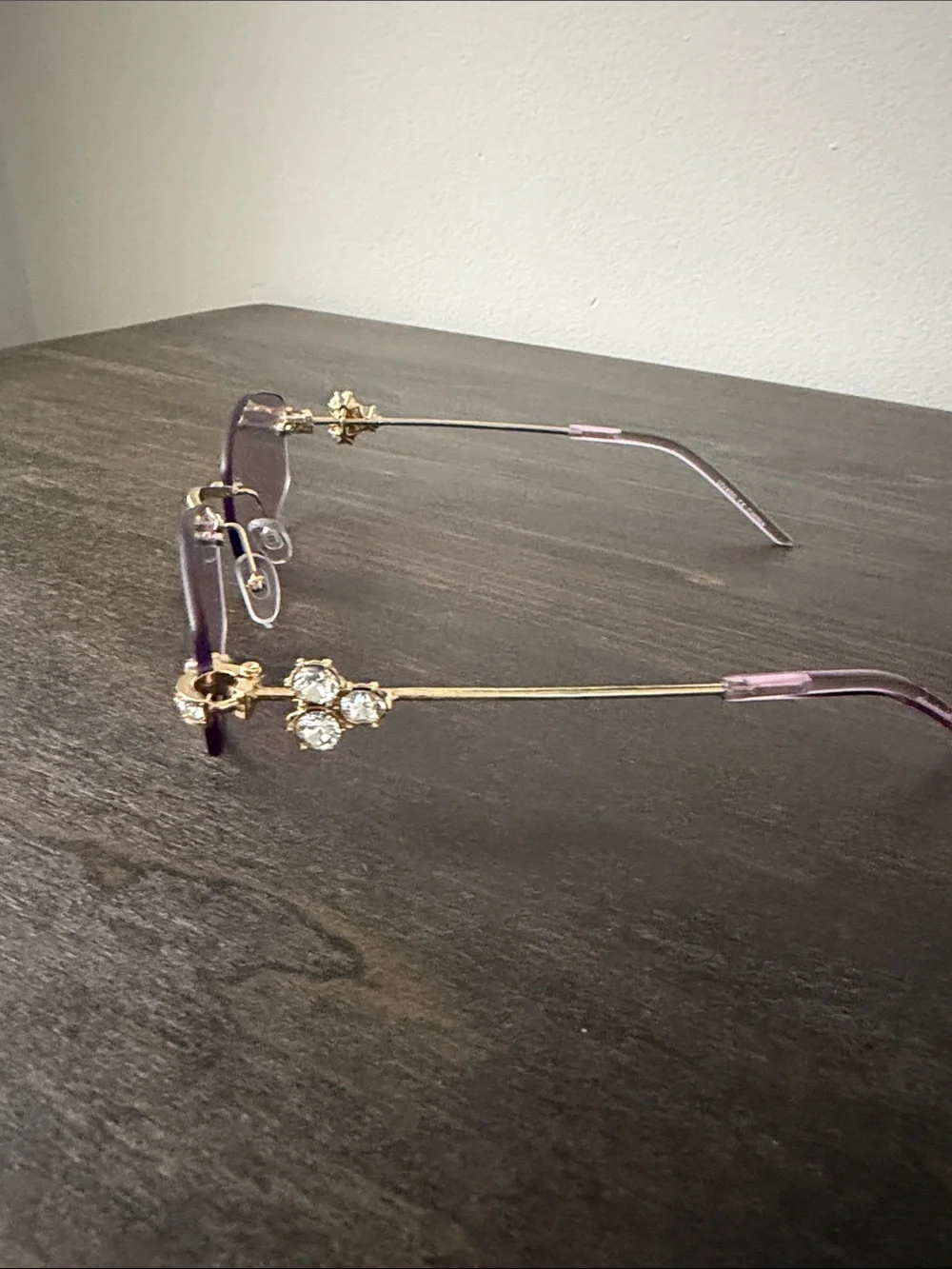 Elegant Rimless Women's Sunglasses with Gold Accents - Purple Lenses